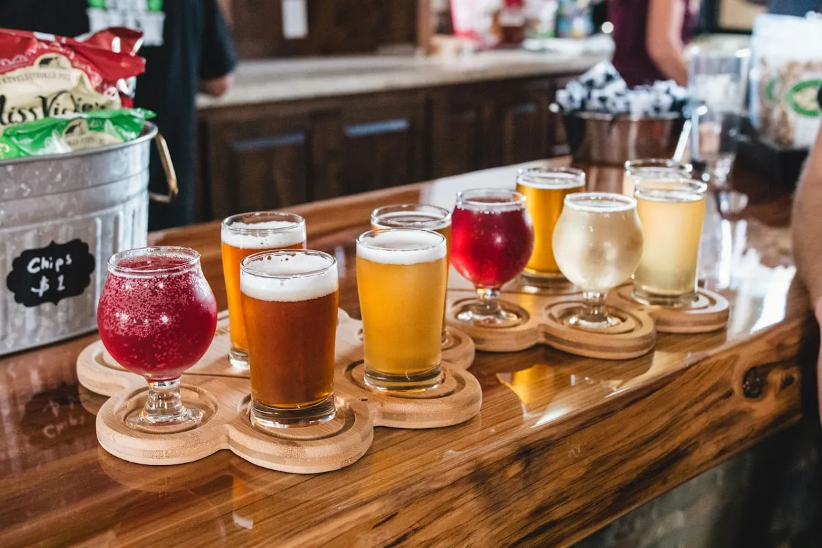 A four-pour tasting flight on a wooden paddle