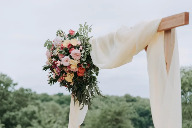 Guests raising glasses in a warm, rustic tavern celebration with amber lighting